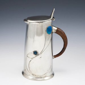 A Tudric Pewter Enamelled Jug and Cover Designed By Archibald Knox