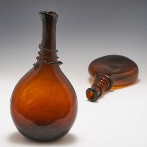 A Persian Brown Glass Funnel Lipped Saddle Flask c1800